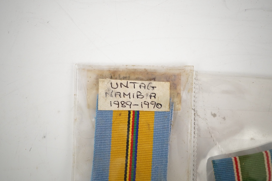 Thirteen United Nations (UN) and NATO medals, eleven UN examples with ‘ in the service of peace’ to the reverse, including a variety of ribbons for a number of different campaigns, (some duplicates), and two NATO ISAF Af